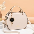Minimalist beige PU leather shell bag for women with round metal handle and cat charm - Off-white