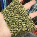 Strands of 2-3mm green natural stone square beads held in hand for jewelry making - 54-Green Garnet (Natural)