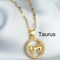 Golden Taurus zodiac pendant necklace with white zircon inlays on a silk background - Taurus