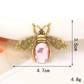 Macro shot of bee accessory with pink crystal inlay and antique bronze metal finish - Antique Bronze Pink Crystal Bee