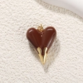 Macro detail of a heart pendant featuring dark brown enamel and gold plated metal finish - Large 3D Chocolate