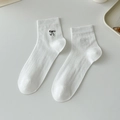 White cotton ribbed socks featuring delicate black embroidered bow detail on the side - One Size / White