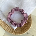 Elegant purple satin scrunchie with silky shine on a decorative woven tray - Grape Purple