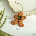 Gingerbread man resin Christmas tree ornament with white icing detail and 8x6.5cm dimensions - Green Bow Gingerbread Man
