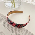 Vintage floral headband with dark fabric and red cherry pattern on newspaper backdrop - Red Floral