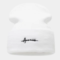 Close-up of white knitted beanie with black cursive letter embroidery on the front cuff - White