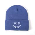 Blue knit beanie with white embroidered smiley face on the cuff for men and women - One Size / Denim Blue
