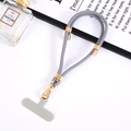 Grey nylon adjustable phone lanyard with gold metal buckle and connector tab on tray - Gray