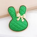 Detail of green rabbit charm with quilted texture and gold metallic bow detail - Vibrant Green