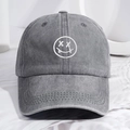 Faded grey washed denim baseball cap with white embroidered tongue-out smiley face - One Size / Gray