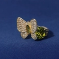 Macro shot of gold butterfly ring with green gemstone and sparkling zircons - Gold Base Olive Green