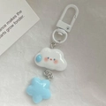 Close-up of cute cartoon cloud and blue star keychain charms on textured surface - White Expression Cloud Star / White