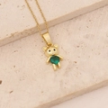 Macro view of golden bear pendant necklace with green gemstone on beige stone - Green Round Stone Bear (1#)