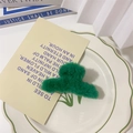 Dark green faux fur hair claw clip placed on a white ceramic plate with a poem card - S / Green