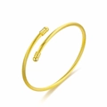 Detail of an elegant gold-plated titanium steel open cable bangle with twisted wire texture - Round Head Style / Gold