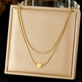 Detail of gold double-layered necklace with sparkling tennis chain and heart pendant - Heart Pendant Snake Chain Double Layer Style (N3591)
