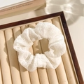 Elegant white floral lace scrunchie made of textured fabric on a beige display tray - White Seersucker