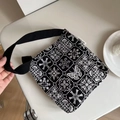 Detail of elegant black canvas shoulder bag with white butterfly embroidery and floral patterns - Small Handheld Underarm Bag