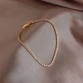 Classic gold tennis bracelet with AAA cubic zirconia on elegant purple silk fabric - Round 3mm / Gold