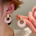 Pink marble textured resin hoop earrings with golden metal clasps on female model - Style 59 Quicksand Texture Thick Hoop