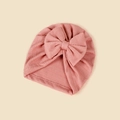 Detail of pink waffle knit baby turban hat featuring a large decorative bow - 18.5x17cm / Dusty Pink