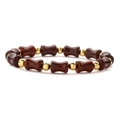 Detail of beaded bamboo-style bracelet with reddish-brown drum beads and gold accents - Southern Red Agate