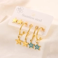 Detailed macro view of 18K gold plated stainless steel star stud earrings and charms - 3 Pairs Blue White Evil Eye Star Set