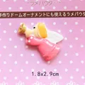 Macro view of a small resin angel charm for DIY crafts, size 1.8x2.9cm with golden hair - Angel with Horn - Pink