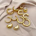 Detailed view of a 12-piece gold hoop earring set on elegant champagne satin fabric - 36# Silver Pin (12-Piece Set) / Gold