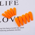 Detail showing ten orange long ballerina press on nails arranged on a white card - Orange