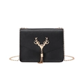 Chic black crossbody chain bag with a golden deer head tassel ornament on white background - Black