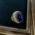 Close-up of vintage gold ring with oval blue gemstone and shimmering crystal pavé detail - K-0855 Lapis Lazuli Open Ring