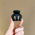 Compact matte black hair claw clip made of plastic held by fingers for size reference - Pumpkin 3cm Matte Black