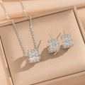 Silver honeycomb jewelry set with crystal pavé necklace and hoop earrings on a display box - Set / Silver