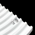 Detailed view of silver triangular stud earrings with petal-shaped backs on white wavy stand - Triangle