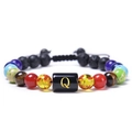 Macro shot of lava stone bracelet with letter Q charm and colorful natural beads - Letter Q