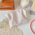 Detailed top view of a cotton floral makeup bag with pink flower patterns on a wooden desk - Multi-Color Floral