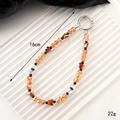 Bruine en oranje kristallen kralen telefoonriem met zilveren sluiting, 16cm lengte - Goudgeel