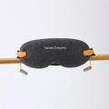 Detailed texture of dark gray knit sleep mask with earplugs on gold bar - Graphic Print / Dark Gray