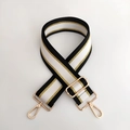 Close-up of adjustable striped handbag strap with gold metal buckles and woven texture - Black White Gold Line