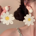 Macro detail of handmade woven daisy earrings with white petals and yellow centers - 12# White Daisy Woven (Steel Pin)