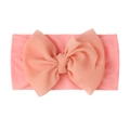 Close-up of pink baby turban headband featuring a large layered chiffon bow decoration - Pink