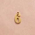 Polished gold number 6 pendant for DIY jewelry on textured pink fabric background - Gold Number 6