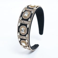 Close-up of black wide headband with geometric crystal rhinestones and gold beads - Gold