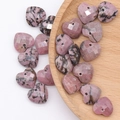 Pink natural stone faceted heart pendants with dark veining in a wooden bowl - Single Piece / Rhodonite