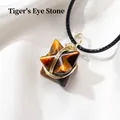 Tiger Eye stone Merkaba star pendant with gold wire wrapping on a black necklace cord - Tiger's Eye