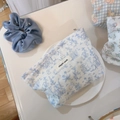 Close-up of blue rabbit pattern cotton cosmetic bag with 'simple wish' label in a tray - White Base Blue Leaves Rabbit