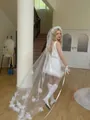 Detail of white bridal veil with bow accents and mini feather wedding dress set - Mid-length Double Layer Petal Veil