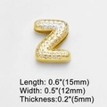 Macro shot of gold letter Z pendant encrusted with white cubic zirconia stones - Letter Z