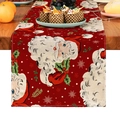 Close-up of a festive red linen table runner with vintage Santa Claus prints on wood - 33X160cm